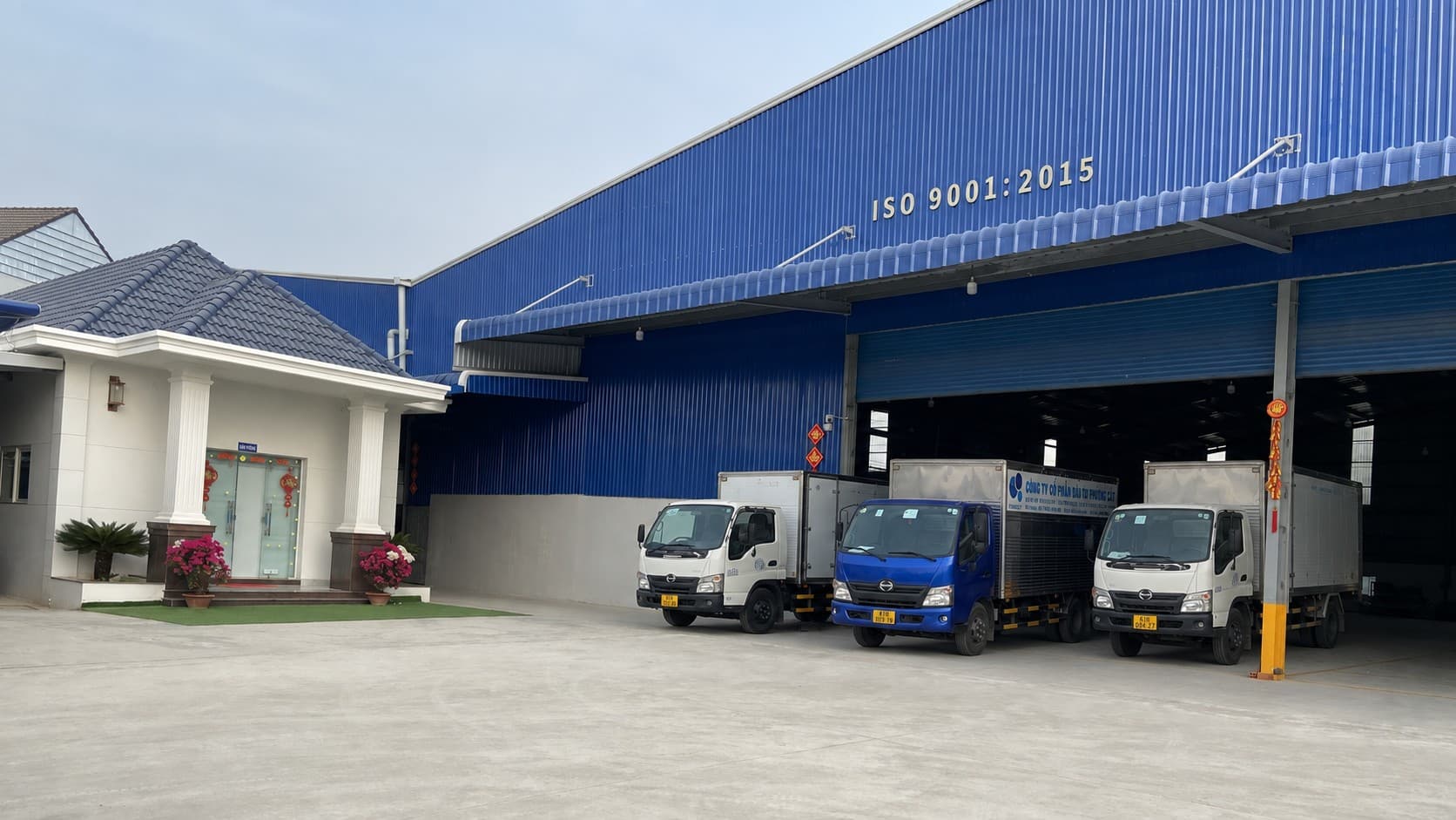 Overview of the Phuong Cat factory, office and three delivery trucks in Ho Chi Minh City
