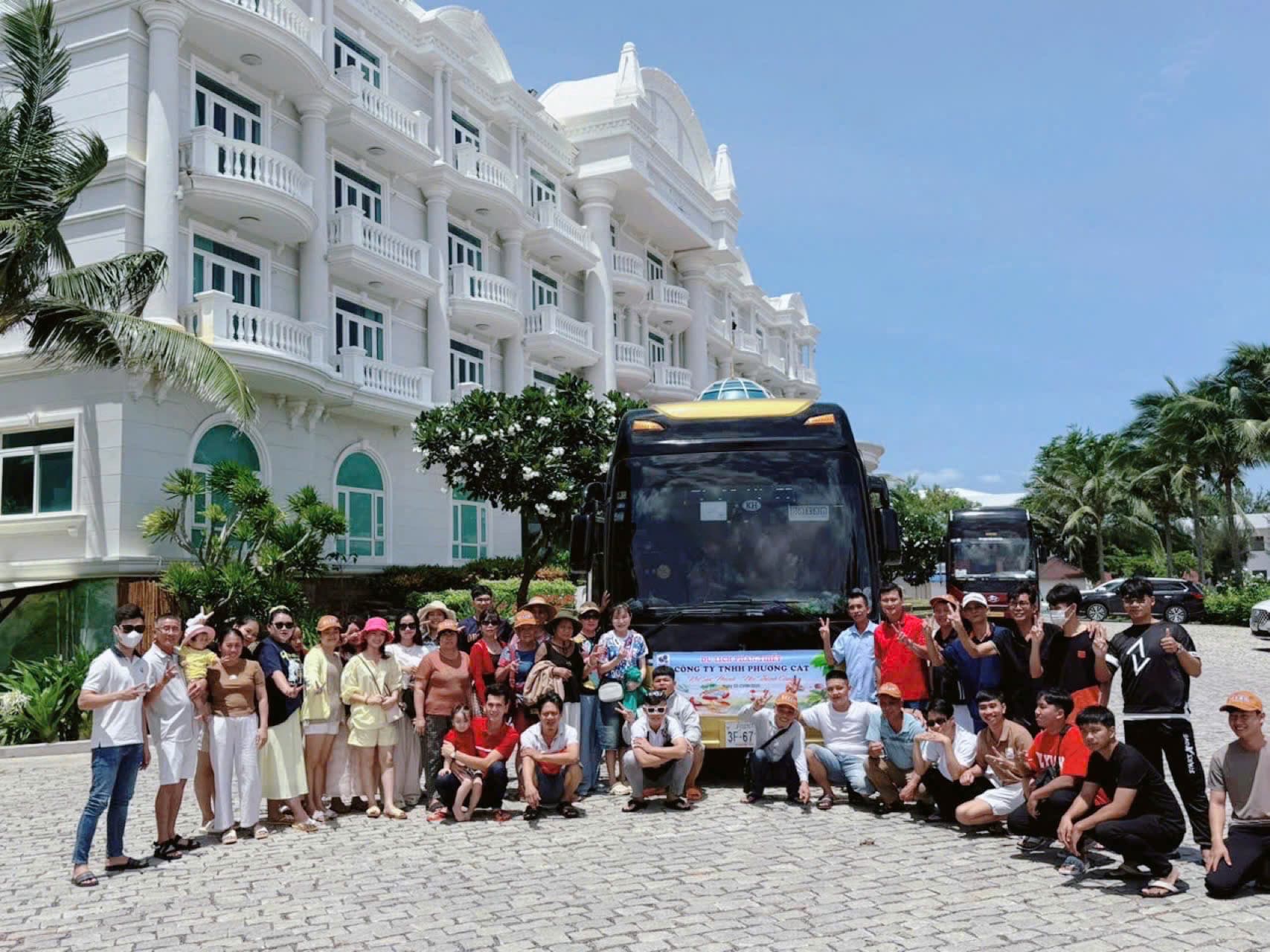 The Phuong Cat team photographed in front of the coach during a company trip