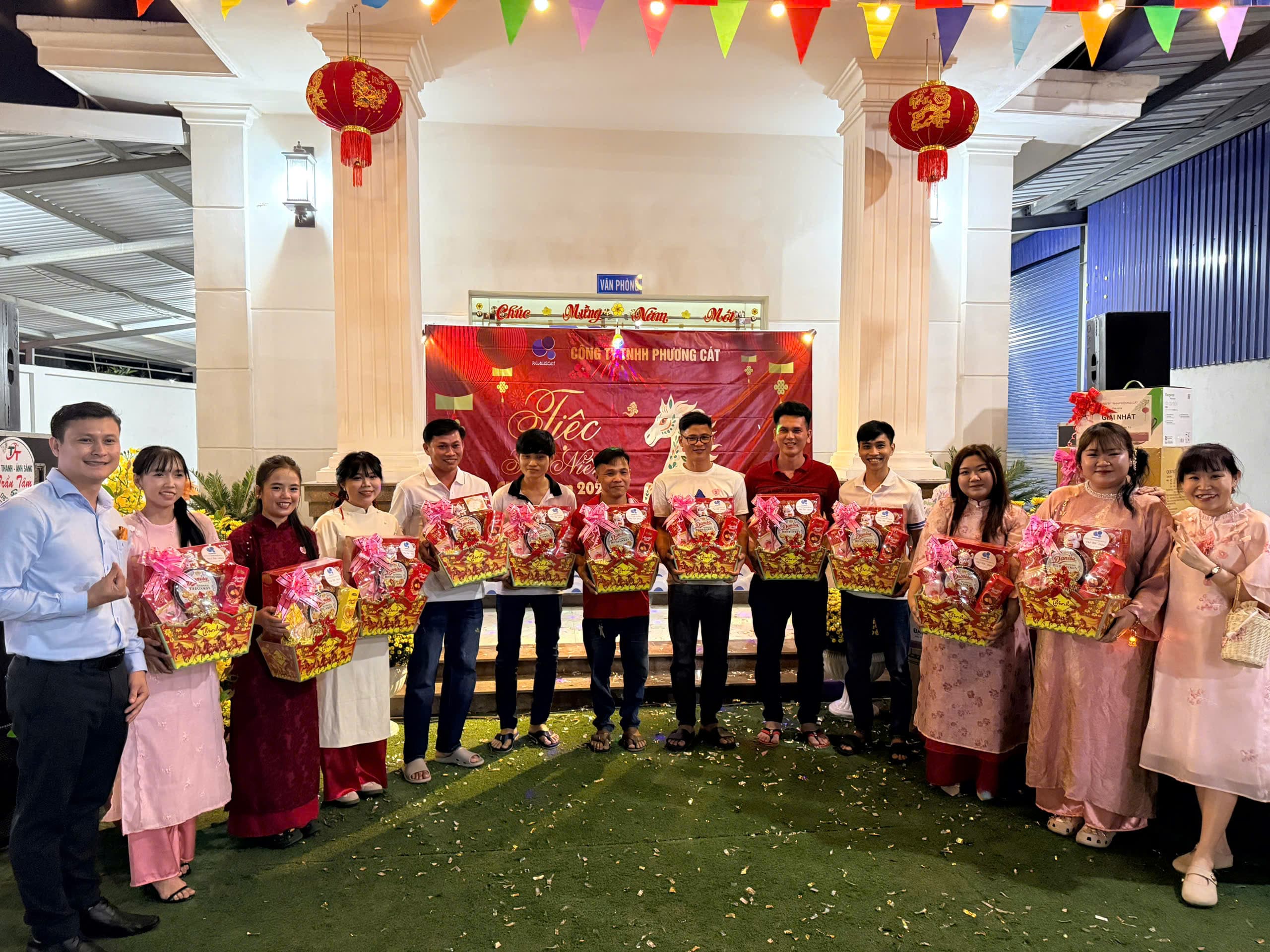 The Phuong Cat team photographed with gifts at a New Year gathering