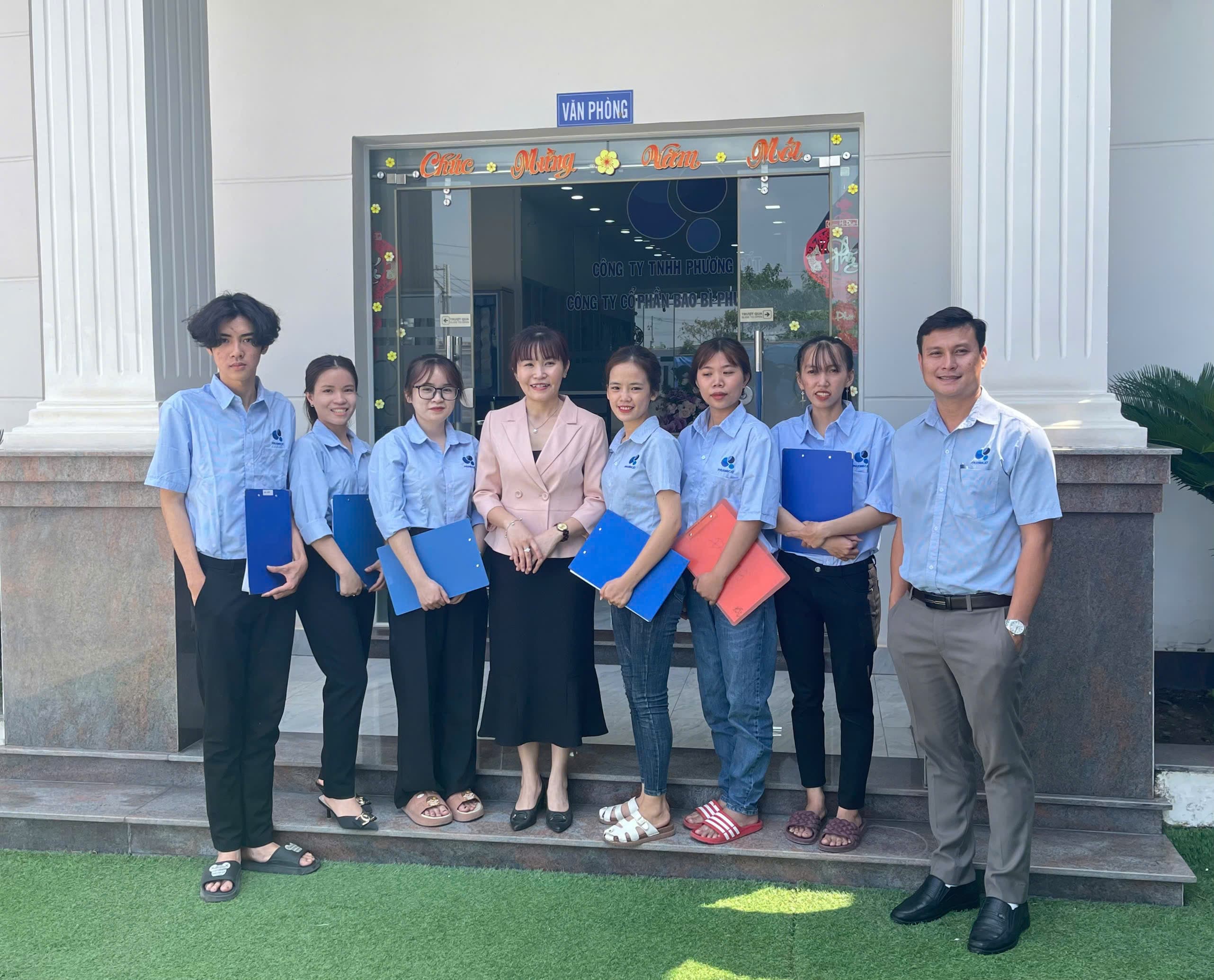 Phuong Cat office team photographed outside the company