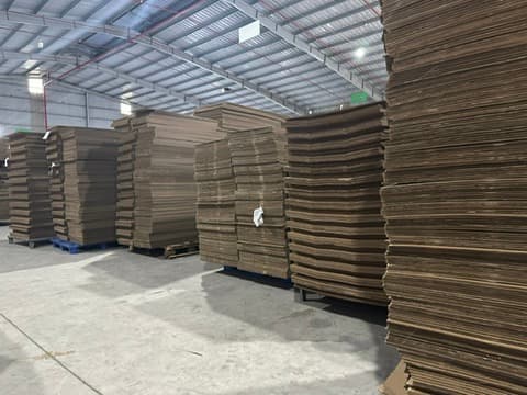 Stacks of carton sheets arranged on pallets in the raw-material store