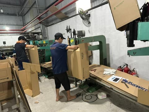 Staff stapling carton boxes at the Phuong Cat factory