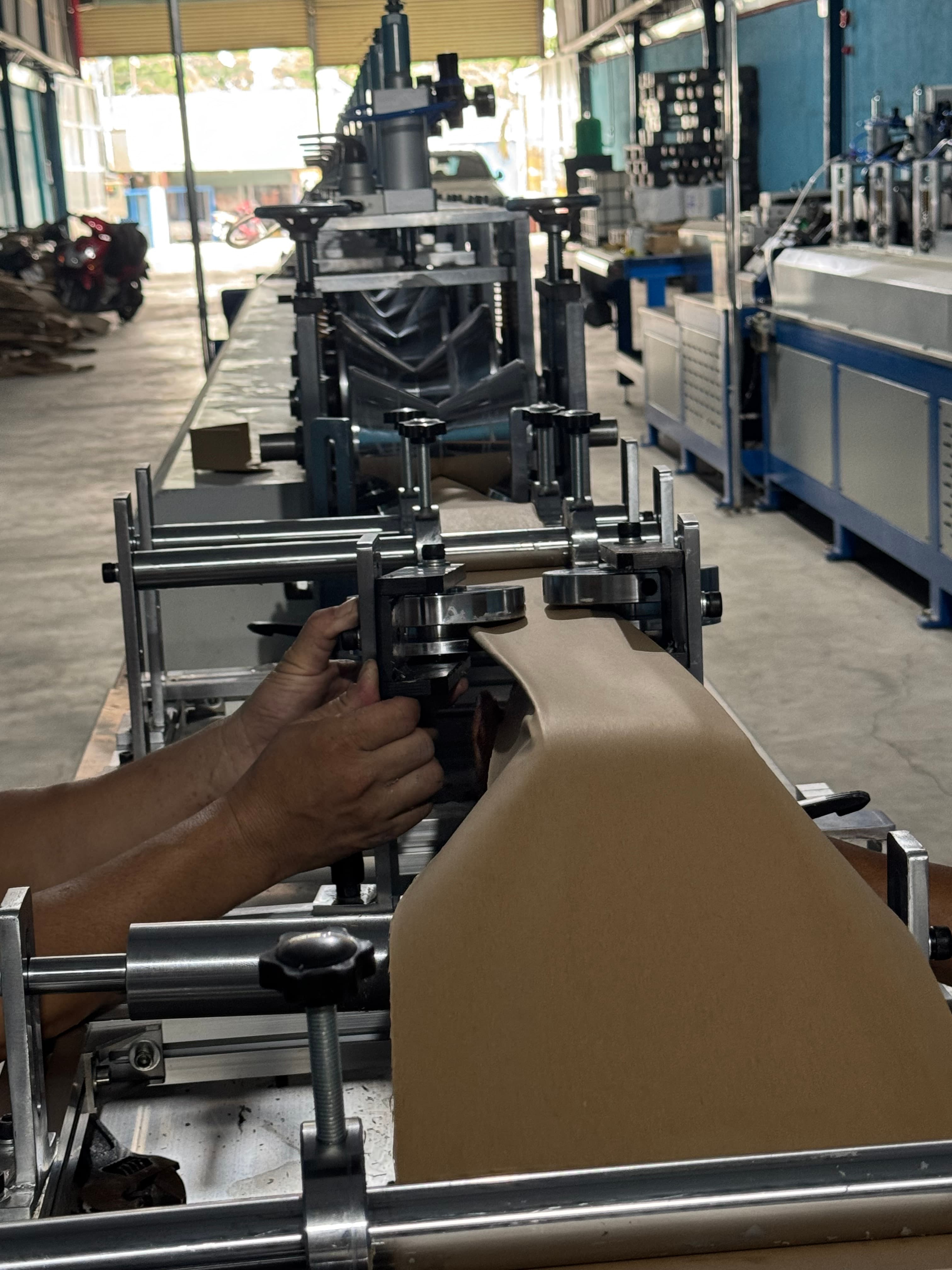 Machine forming V-shaped paper corner protectors in the Phuong Cat production area