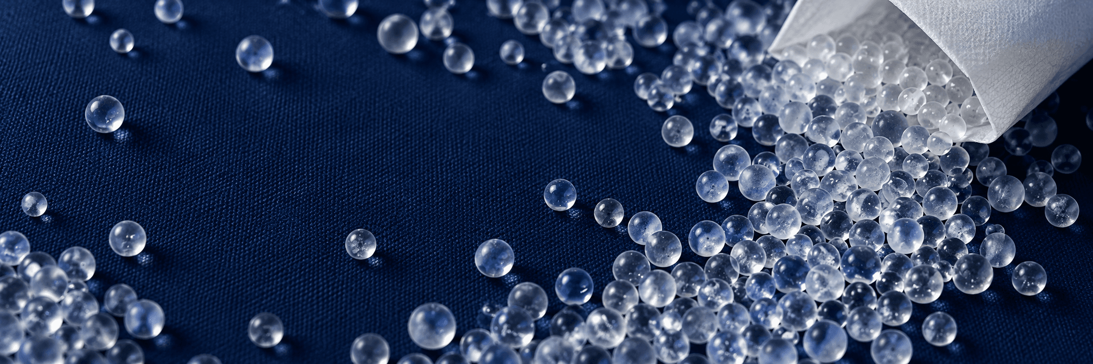 Clear silica gel beads on a blue background